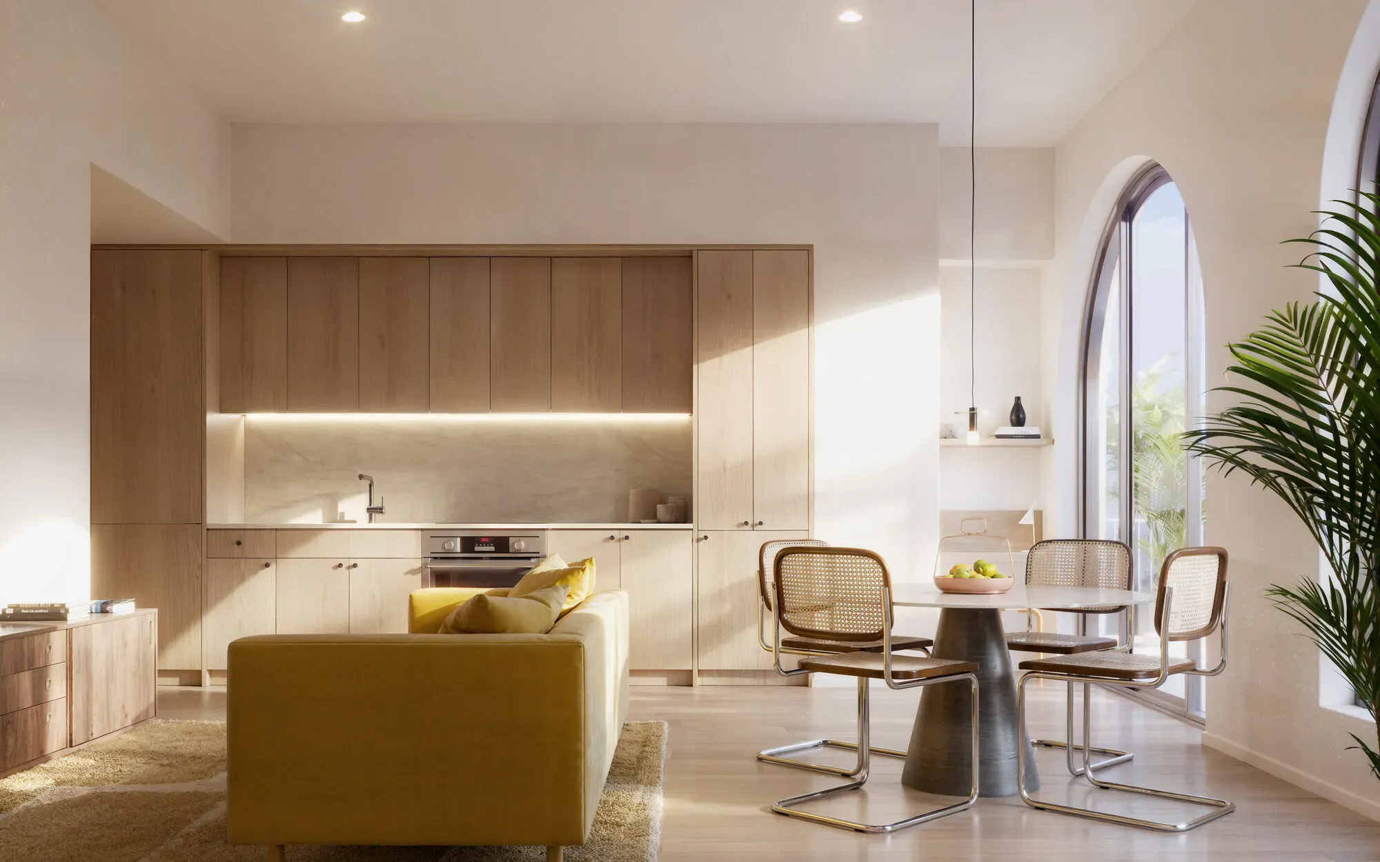 Modern open-concept apartment with mustard yellow sofa, wooden kitchen, dining table, and contemporary furnishings